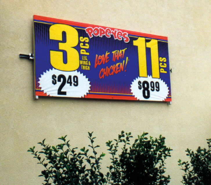 Mounted banner frames as exterior merchandising from Voxpop Marketing Systems Wall mounted banner frames and signboards displaying deals