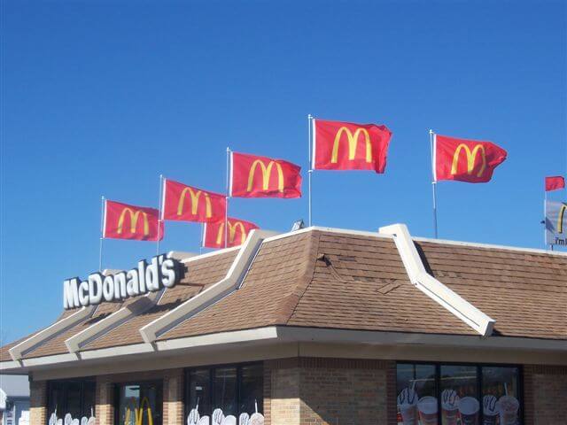 Rooftop displays using flags from Voxpop Marketing Systems A rooftop display on McDonald's with flags using their logo