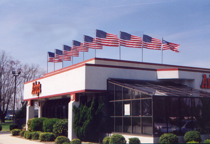 Flag poles for rooftop displays from Voxpop Marketing Systems American flags on an Arby's Rooftop display