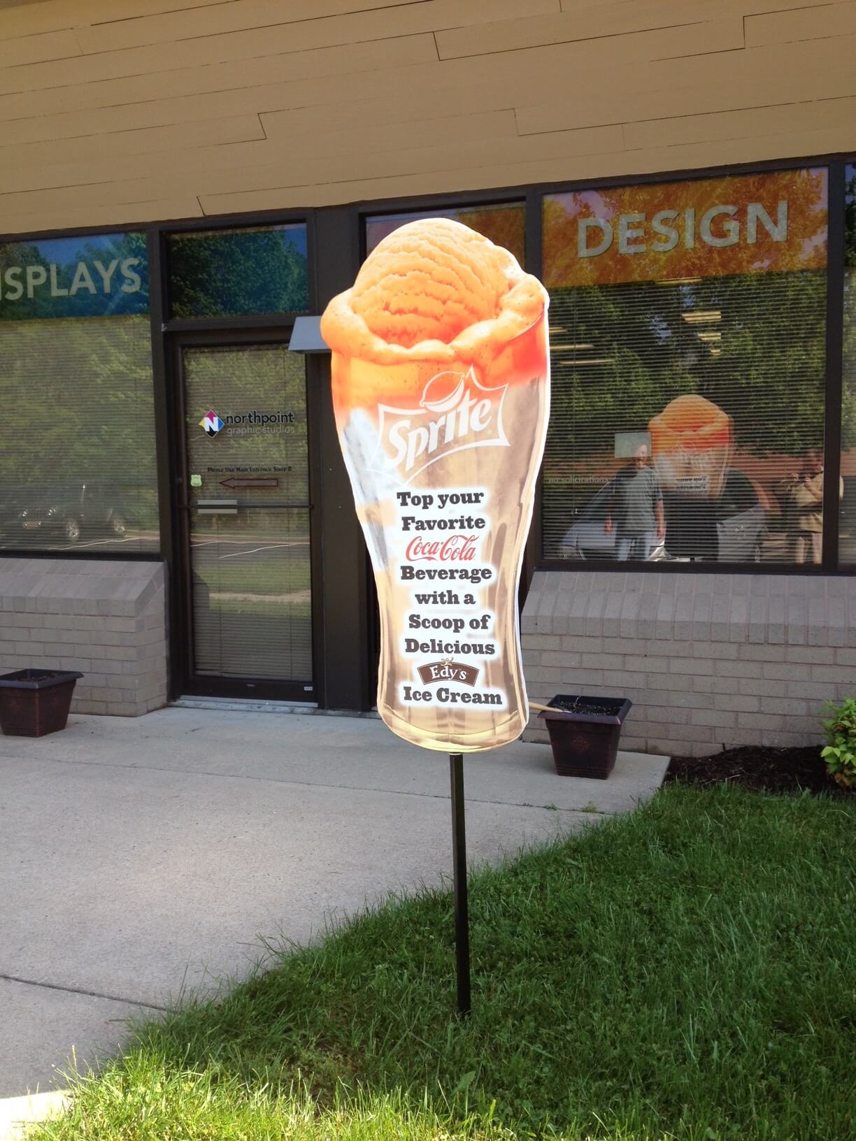 Outdoor marketing using Sign Board displays as exterior merchandising A sign board display on the lawn as exterior merchandising