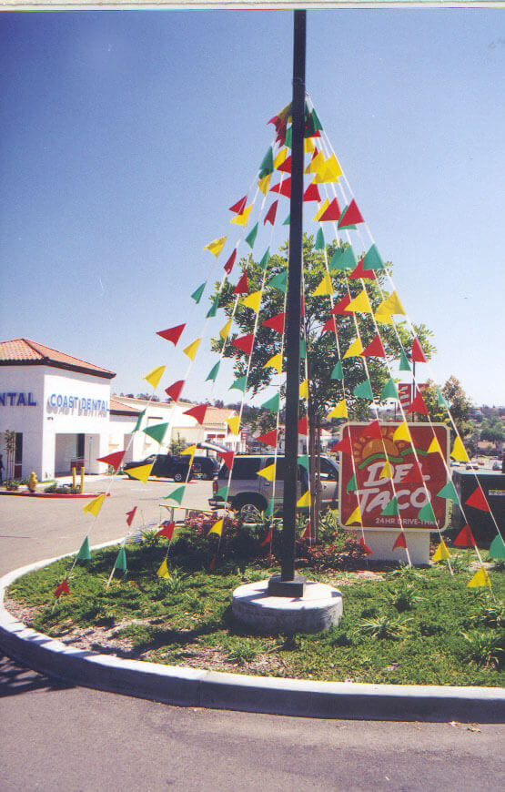 Pennant strings with Blade flags from a leading manufacturer of flags and flag poles Blade flags outdoor displays in front of Del Taco