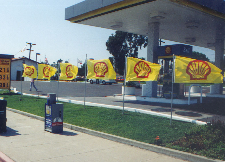 Flags used as ground displays from Voxpop Marketing Systems leading manufacturer of flags and flag poles Sidewalk displays of Shell gas station flags